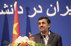 Iranian President Mahmoud Ahmadinejad gestures as he delivers a speech in front of a Chinese national flag at the Peking University in Beijing