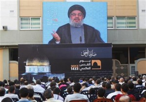 Lebanon's Hezbollah leader Sayyed Hassan Nasrallah addresses his supporters via a screen, during a rally marking "Quds (Jerusalem) Day",in the southern suburbs of Beirut