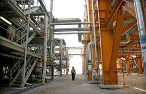 Worker walks amid facilities at phases 2-3 of the South Pars gas field are illuminated at night in Assaluyeh on Iran's Persian Gulf coast