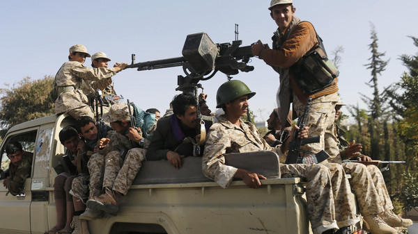 Houthi fighters ride a truck while patrolling a street in Sanaa