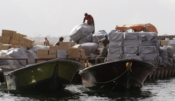 Iranian smugglers load goods at the Omani port of Khasab, Sept. 26, 2012. (photo by REUTERS/Ahmed Jadallah)